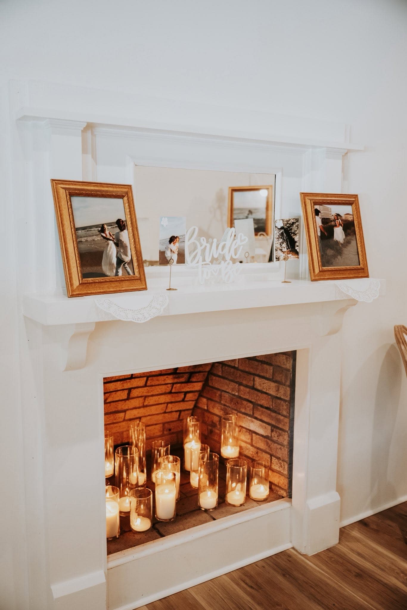 White mantel display with candles and bridal photos in the Becker Hill getting ready suite